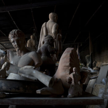 In this Friday, Oct. 13, 2017 photo, the bust of the ancient Greek messenger of the gods, Hermes, left, stands among other statues and antefixes in Haralambos Goumas' sculpture and ceramic workshop, in the Egaleo suburb of Athens. (AP Photo/Petros Giannakouris)