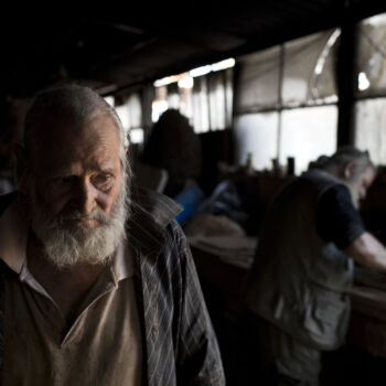 In this Friday, Oct. 13, 2017 photo, pensioner Panayotis Goumas, 74, helps his brother Haralambos in his sculpture and ceramic workshop, in the Egaleo suburb of Athens. (AP Photo/Petros Giannakouris)