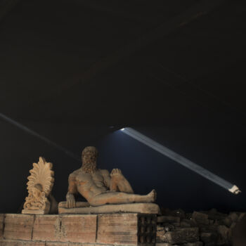 In this Friday, Nov. 20, 2017 photo, a sooty, dust-covered terracotta statue of Greek mythological hero Hercules, a son of Zeus, stands on top of a burning furnace next to an antefix in Haralambos Goumas' sculpture and ceramic workshop, in the Egaleo suburb of Athens. (AP Photo/Petros Giannakouris)
