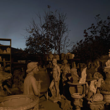 In this Friday, Nov. 20, 2017 photo, the terracotta statue of Ares, the ancient Greek god of war, middle, stands among other statues, busts, antefixes and flowers pots in the yard of Haralambos Goumas' sculpture and ceramic workshop, in the Egaleo suburb of Athens. (AP Photo/Petros Giannakouris)