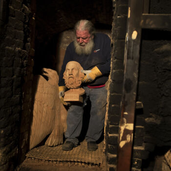In this Thursday, Dec. 21, 2017 sculptor and ceramicist Haralambos Goumas carries out of a furnace the bust of Homer, whom Greek tradition named as the author of the Iliad and Odyssey epics, at his workshop in the Egaleo suburb of Athens. (AP Photo/Petros Giannakouris)