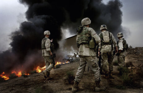 Francesco Zizola - US Marines take control of a weapons warehouse after it was emptied and set on μfire by looters. Baghdad, Iraq. May 2003.