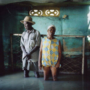 Gideon Mandel - Christa Raymond Fils and her husband Salomon Raymond Fils in Decade in southeast Haiti. Their house was flooded and damaged by Hurricane Gustav. During the hurricane season of 2008 Haiti was subjected to four destructive hurricanes in the space of twenty days. This increasing severity and quantity of hurricanes is one of the effects of climate change. Haiti is extremely vulnerable to these hurricanes due to deforestation of its mountains for the production of charcoal. “Every bit of furniture had been either ruined or carried away by the water. All we have now is a few clothes. The water took everything. All the houses round here were the same – full of water. As long as I’ve lived, I have never seen a hurricane like this one. In previous years we did have hurricanes, but this time we can’t even stay in our home any more.”